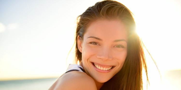 Photo of a happy woman smiling outdoors