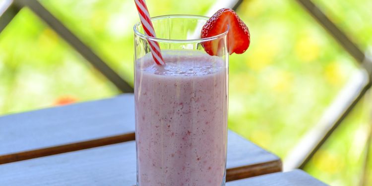 Photo of strawberry papaya smoothie in a glass