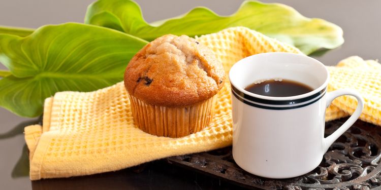 Photo of a muffin and coffee in a cup