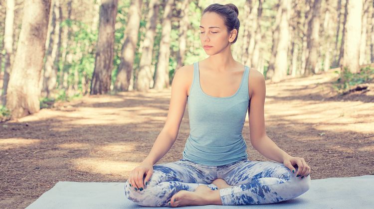 Photo of a girl meditating in nature