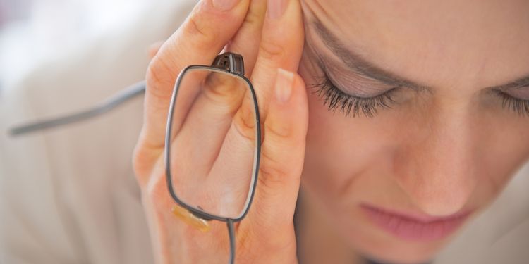 Photo of a stressed businesswoman with eyeglasses