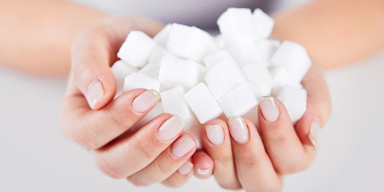 Photo of sugar cubes in hands