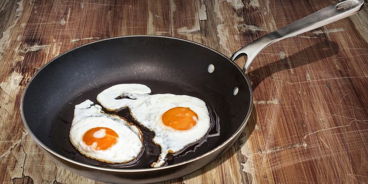 Photo of eggs frying in teflon pan