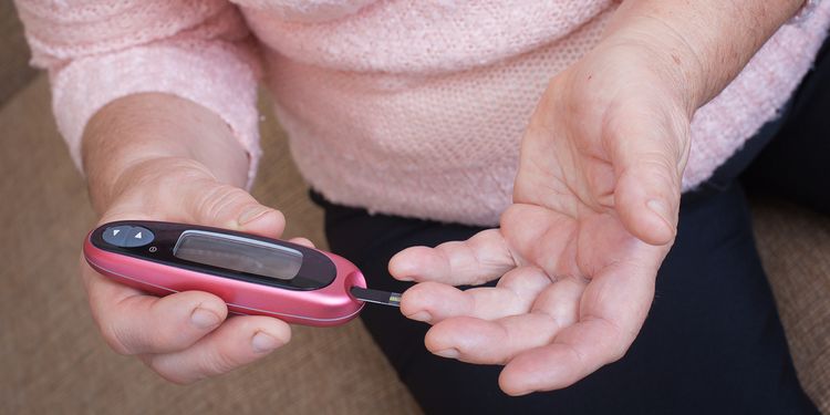 Photo of a person measuring blood sugar