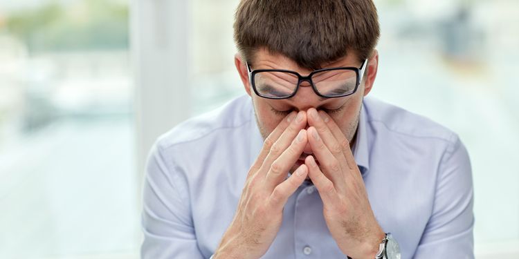 Photo of a tired businessman with glasses