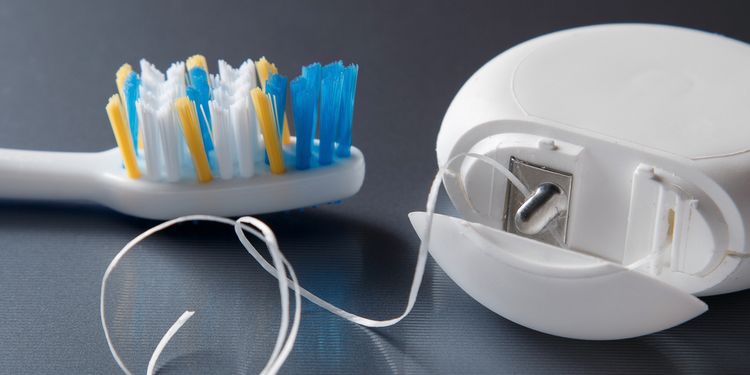 Close up of toothbrush and dental floss 