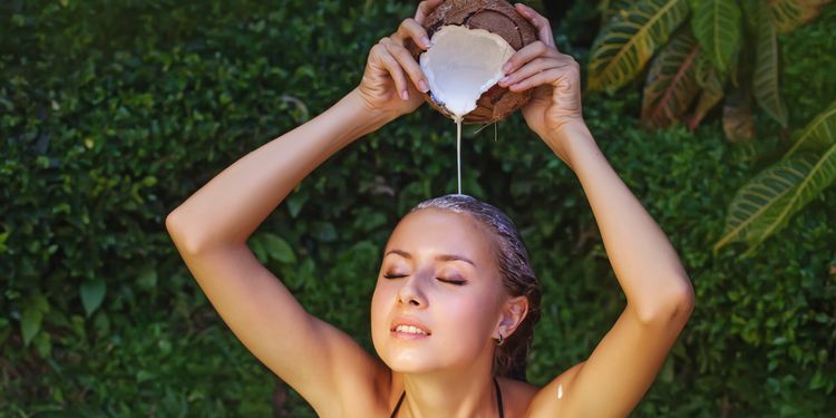 Photo of a girl using coconut milk on hair