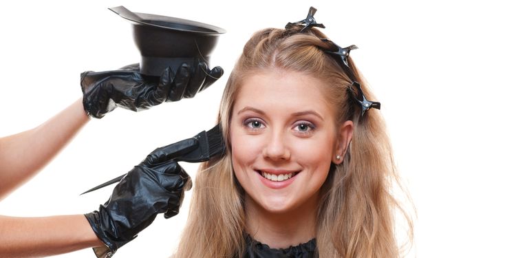 Photo of a woman using hear dye on her hair