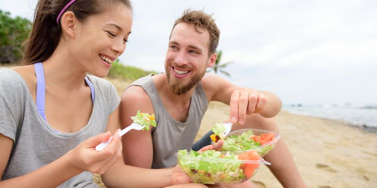 Photo of two people eating vegan dish