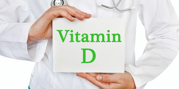 Photo of a doctor holding paper with VITAMIN D written on