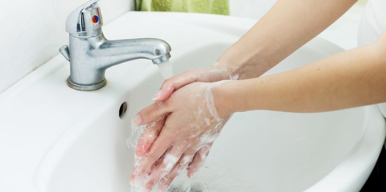 Photo of a person washing hands with soap