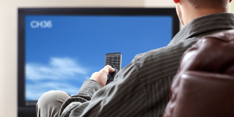 Photo of a sedentary man watching TV