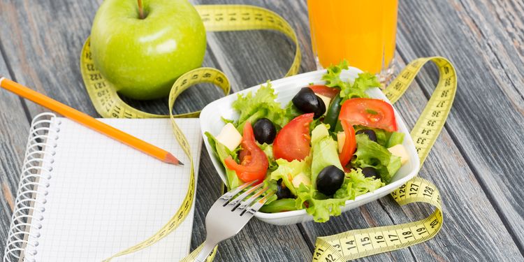 Photo of a notepad next to healthy foods