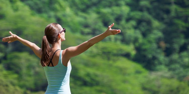 Photo of a young woman feeling free enjoying the great outdoors