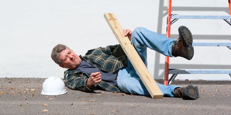 Photo of an injured construction worker who just fell from a ladder on a construction job